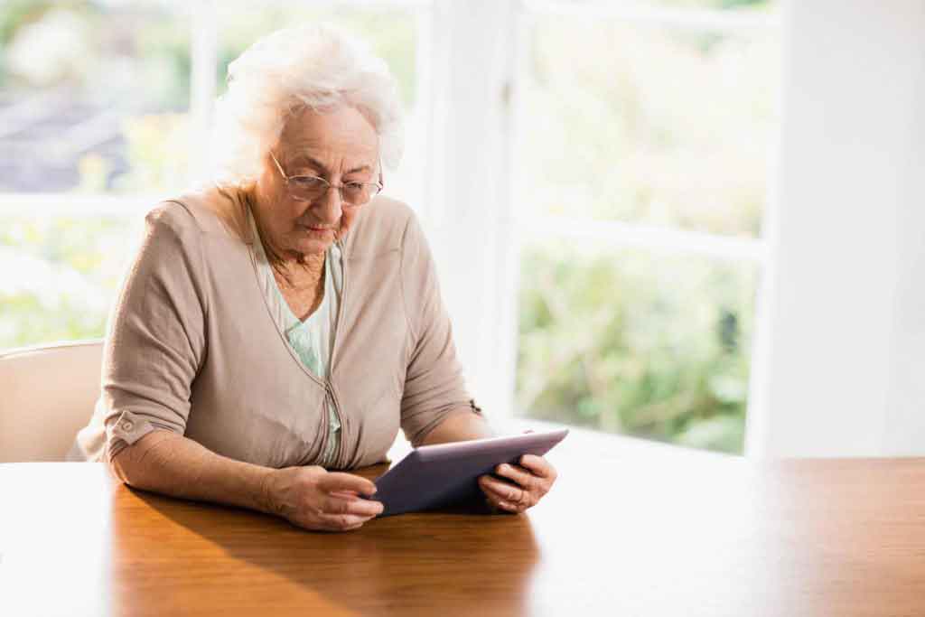 older woman using ipad