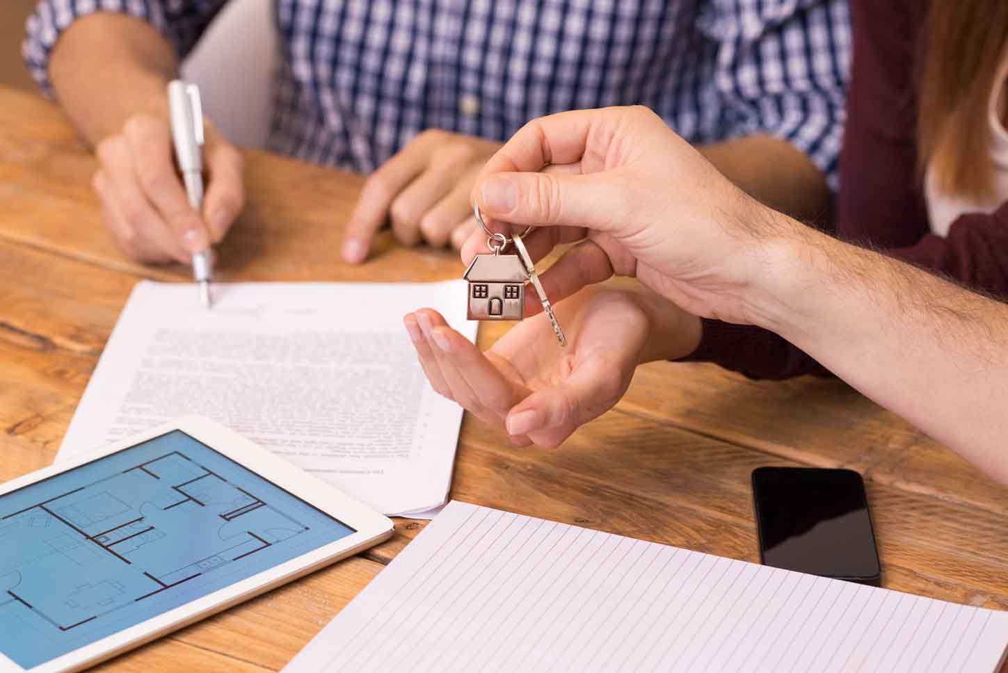 Close up hands receiving house keys