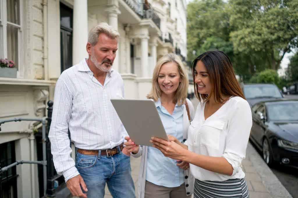 Real estate agent showing house to a couple