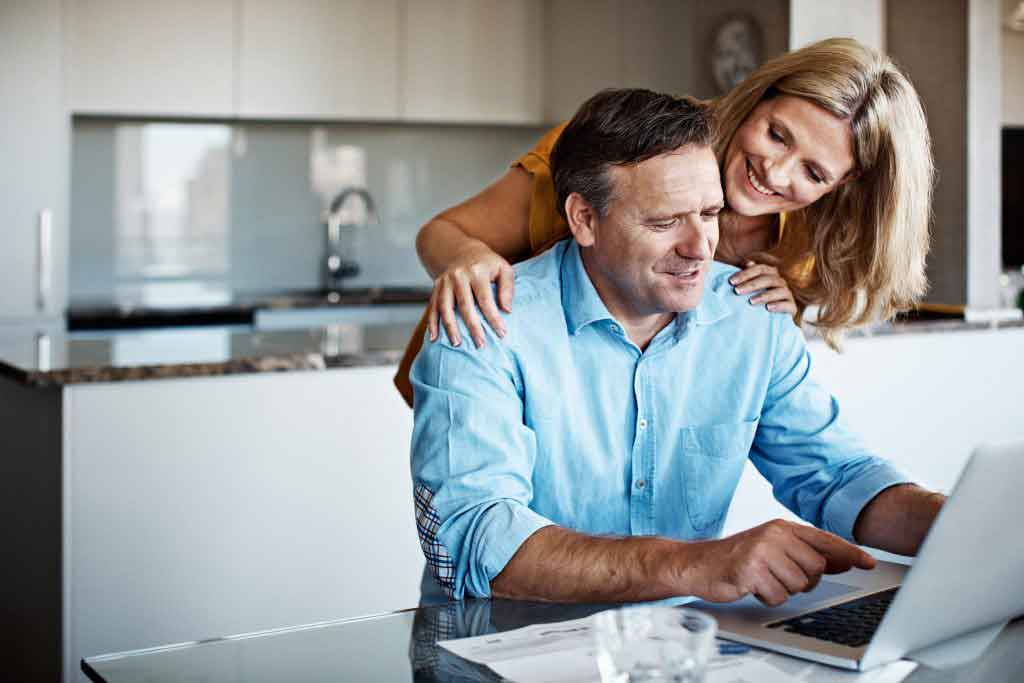 couple researching real estate agents online