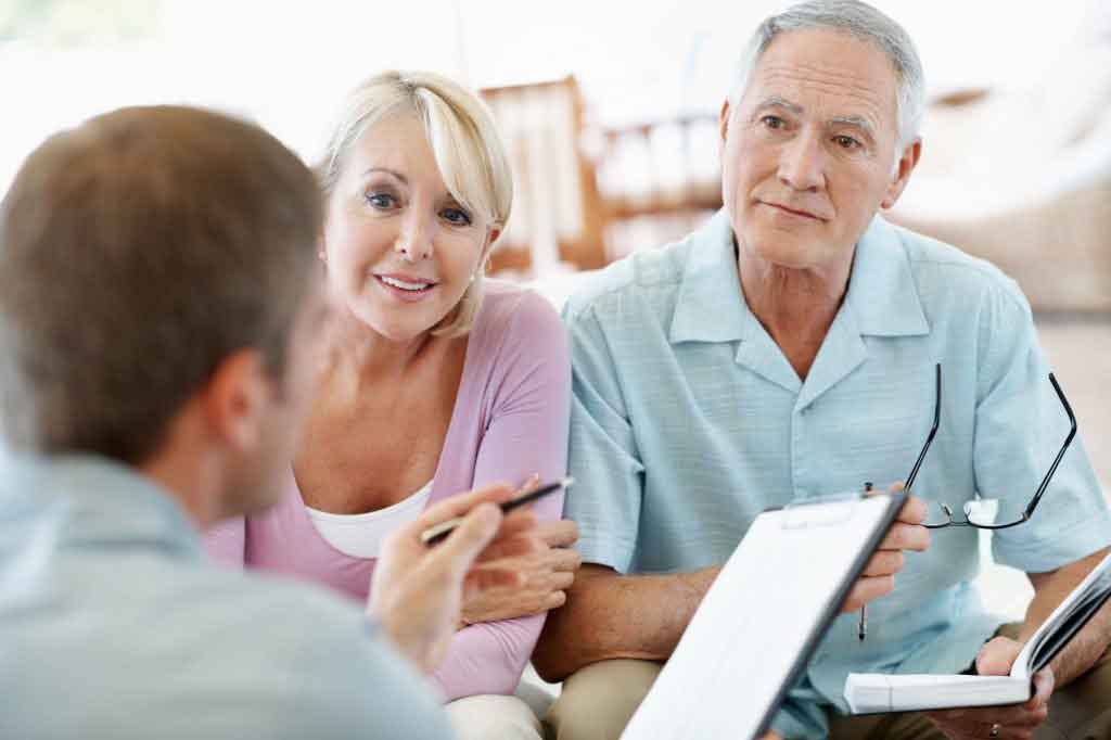 Couple talking with real estate agent about exclusive listing